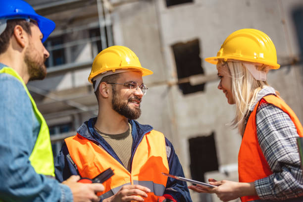 istock Construction team planning a building blueprint project on site with collaboration for architect innovation. 2133421209