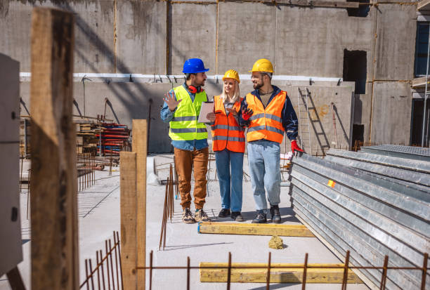 istock Construction team planning a building blueprint project on site with collaboration for architect innovation. 2133426976