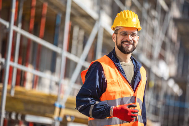 istock Construction site manager standing  wearing safety vest and helmet, thinking at construction site. 2133430090