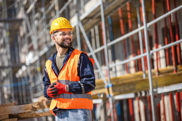 istock Construction site manager standing  wearing safety vest and helmet, thinking at construction site. 2133430618