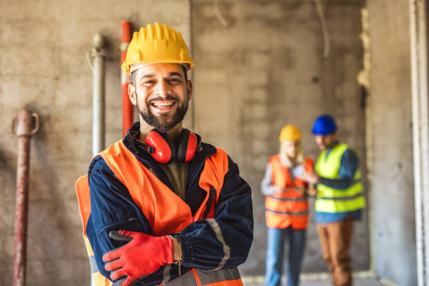 istock Construction site manager standing  wearing safety vest and helmet, thinking at construction site. 2133432675