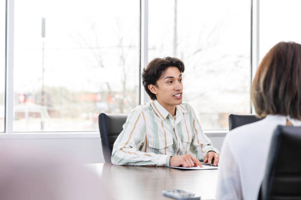 istock Businessman leads team meeting with unrecognizable staff 2133473634