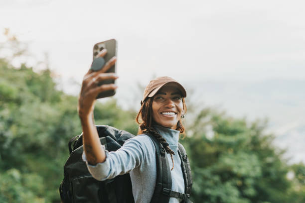 istock Female backpacker enjoying a selfie in nature park 2133477101
