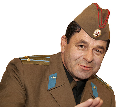 Isolated portrait on a white background of an officer lieutenant colonel of the Soviet army in a soldier's cap, humor, emotion.
