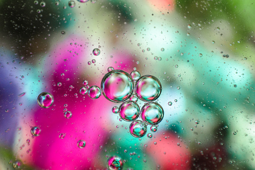 Macro shot of oil bubbles floating on water