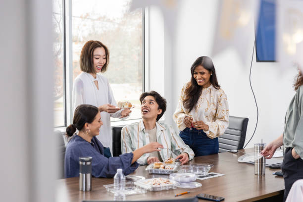istock At party in conference room, employees enjoy break from work 2133502584