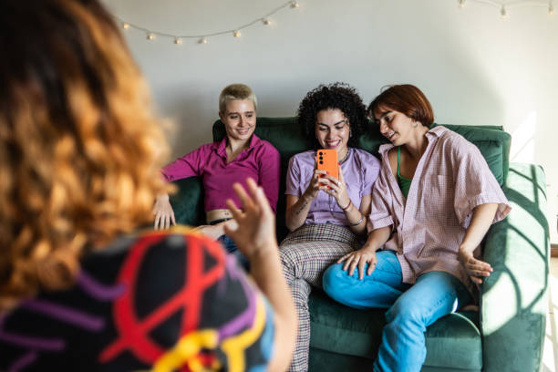 istock Females friends filming using mobile phone on sofa at home 2133505217