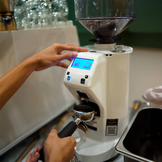 istock Barista is grinding coffee with a grinder 2133508380