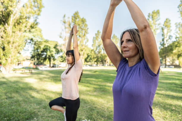 istock Mature friends practicing yoga at park 2133522096