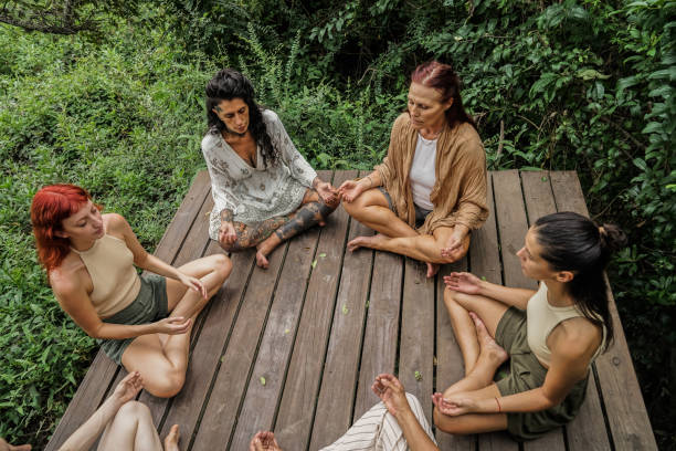 istock Group of women practicing yoga at nature 2133542678
