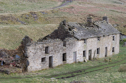 Ruins of an abandoned farmhouse in remote countryside