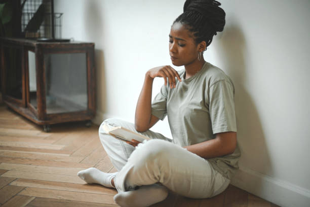 istock Young woman reading a book 2133561882
