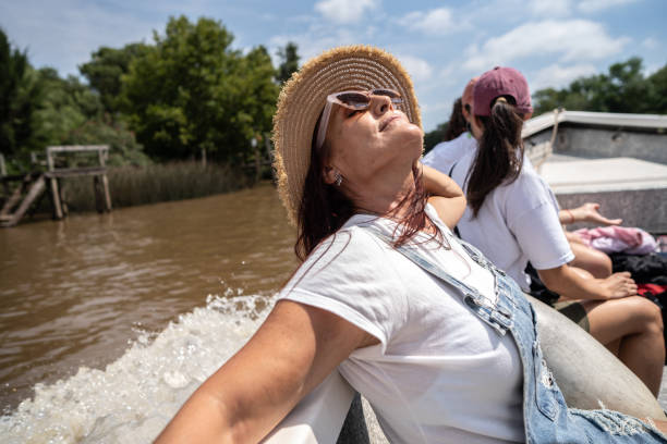 Senior woman doing a boat trip at river