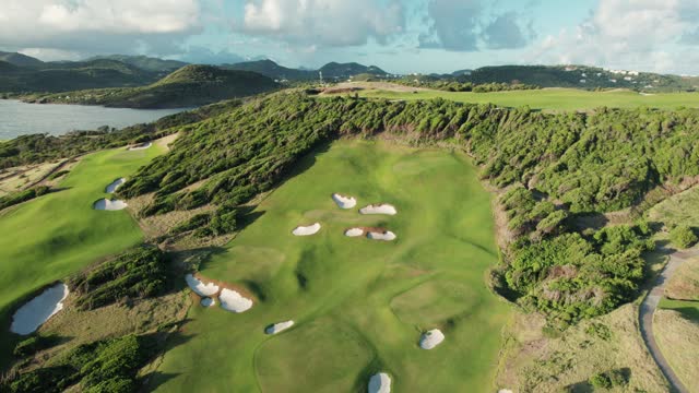 Golf course with bunkers and green grass. Lush tropical landscape in Saint Lucia, Caribbean