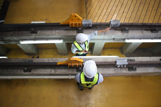 istock Engineer or Professional technician  railroad tracks of electrical or sky train in factory workplace. Maintenance plant of Sky Train. 2133615143