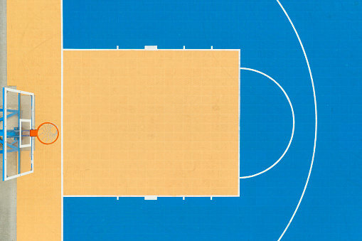 Directly above of the blue and yellow basketball court.
