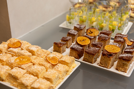 Different kinds of dessert at a banquet dedicated to a wedding, birthday or other festive date.