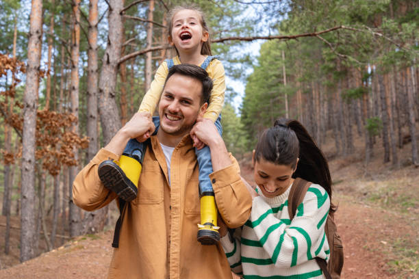 istock Father carrying daughter on shoulder, during hike through forest 2133631830