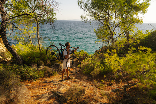 Photo of a man exploring the coastline on a bicycle