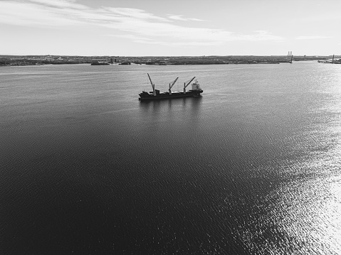 Aerial view of a cargo ship at anchor.