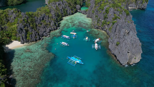 istock Tropical island with boats in lagoons 2133673776