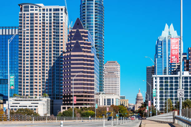 Austin, Texas, USA - Cars and people crossing Congress avenue bridge on a sunny day.