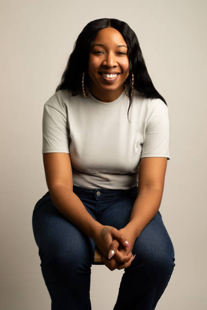 istock African-American woman smiling while sitting down 2133699582