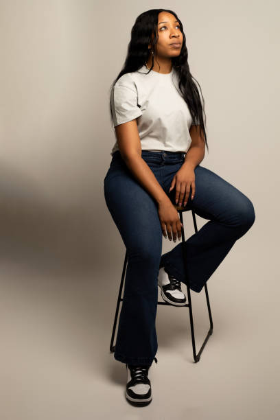istock African-American woman looking away while sitting down 2133699598