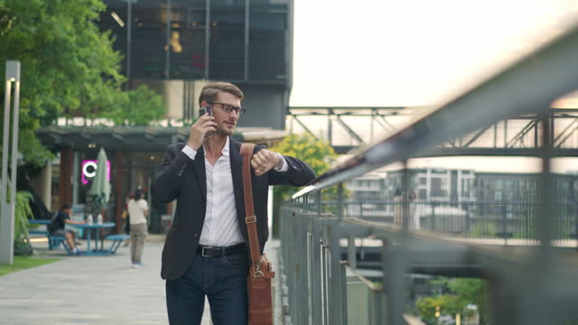 Businessman Walking and Talking on the Phone