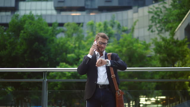Businessman Checking Time During Phone Call