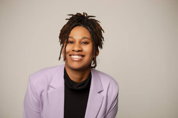 istock African-American woman with locs smiling while leaning forward 2133713497