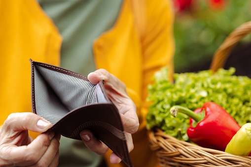 Senior woman holding empty wallet