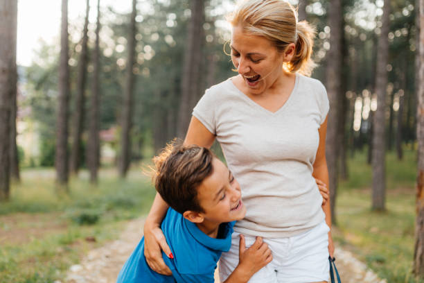 istock Mother embrace her son while walking together in the nature 2133753710