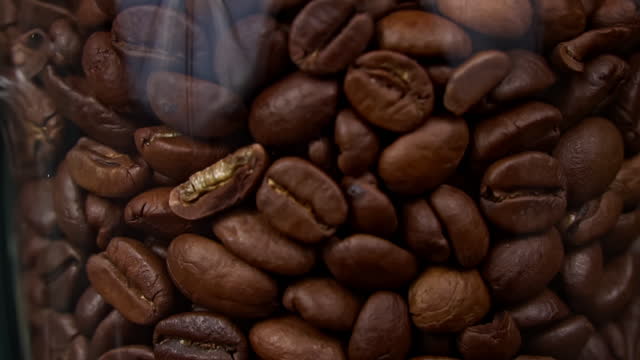 Coffee Beans Fall in Slow Motion and Cover the Entire Screen