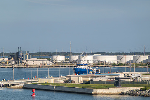 Port Canaveral, Florida, USA - July 30, 2023: Northstar Responder pollution control vessel between Seaport tanks and NOTU naval base under blue sky