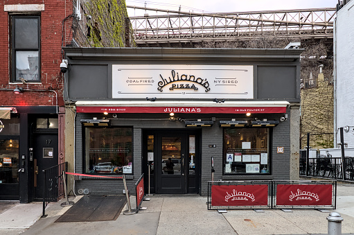 Brooklyn, NY - Apr 1, 2024: Juliana's coal fired thin crust pizza restaurant founded by Patsy Grimaldi sign on their pizzeria in Dumbo, downtown Brooklyn, New York City.