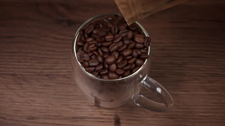 Coffee Beans in Craft Packaging Fall into a Cup