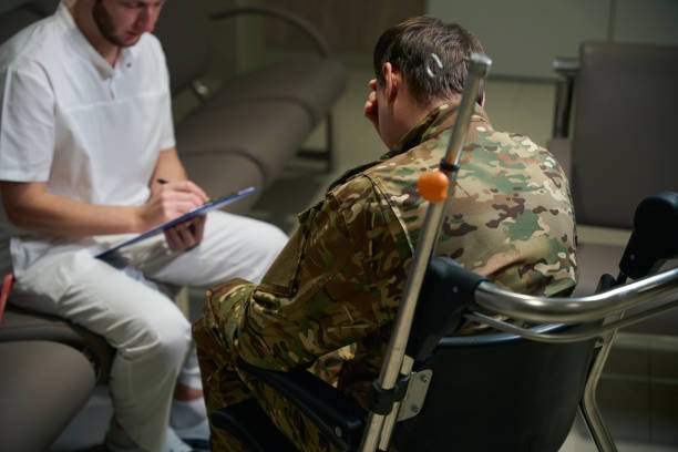 istock Focused doctor writing down complaints of serviceman with disability 2133856470