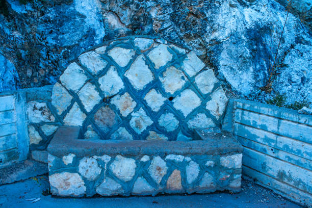 A sculptural fountain in nature, where water flows with artistic elegance, creating a serene and tranquil oasis in the natural landscape