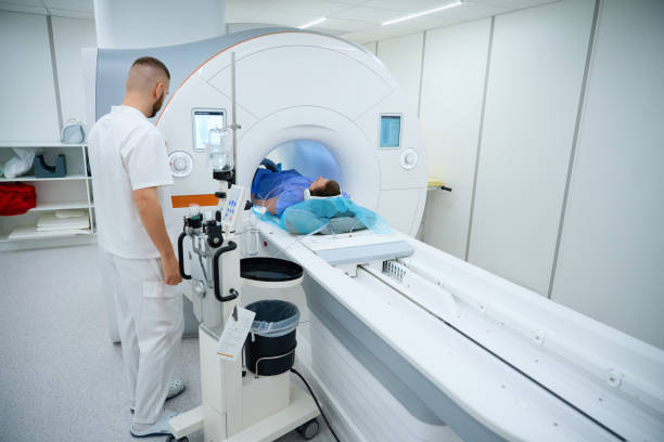 istock Doctor preparing man for knee magnetic resonance imaging procedure 2133871012