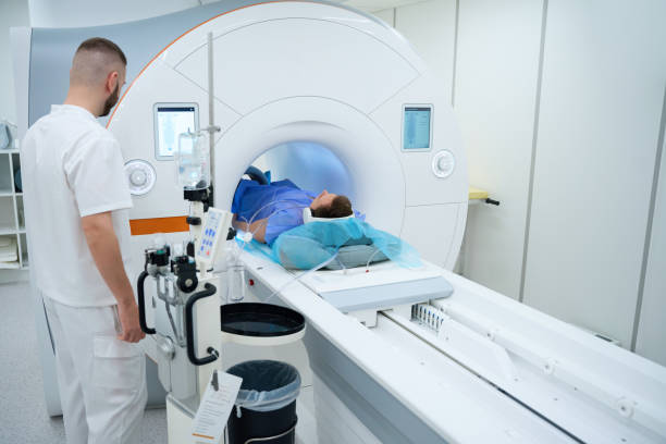 istock MR tech preparing man for knee magnetic resonance imaging with contrast 2133871022