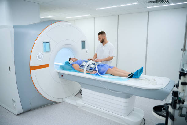 istock Radiographer preparing client for abdominal magnetic resonance imaging procedure 2133871025