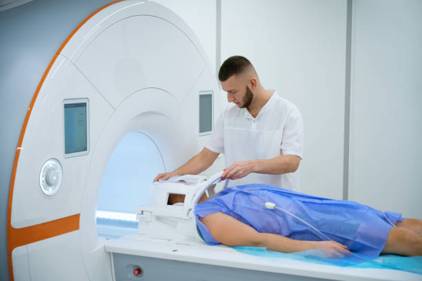 istock Radiographer preparing man for brain magnetic resonance imaging procedure 2133871032