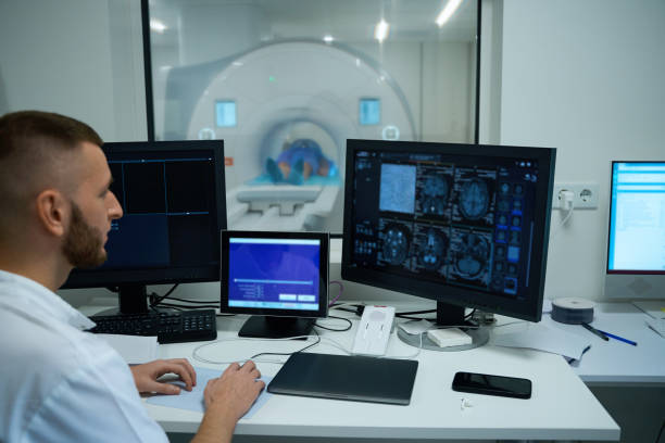 istock Technologist conducting head MRI on adult person 2133871036