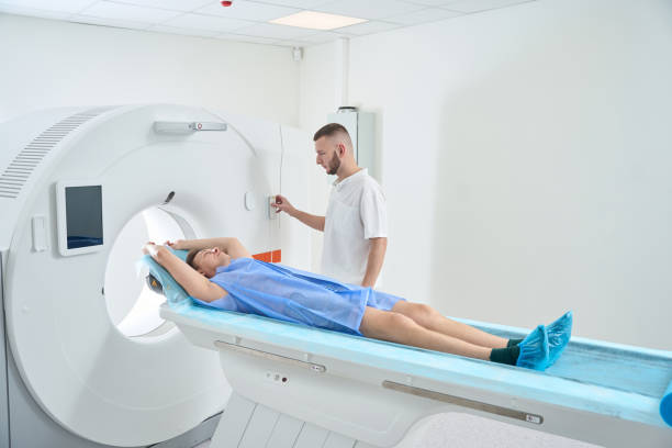 istock Radiologic technologist preparing adult man for computed tomography 2133871049
