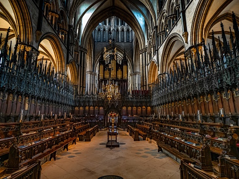 Lincoln Cathedral, Roman Catholic Gothic church and cathedral with stain glass window corridor and hall, with arches, columns, pews, vault, aisles, gallery, arcades and clerestory.