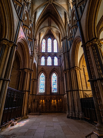 Lincoln Cathedral, Roman Catholic Gothic church and cathedral with stain glass window corridor and hall, with arches, columns, pews, vault, aisles, gallery, arcades and clerestory.
