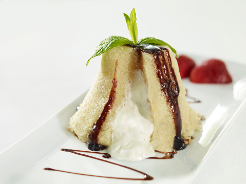Semolina halwa dessert with ice cream filling and chocolate fudge on restaurant table top