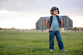 Young Boy with Jetpack in Grassy Field