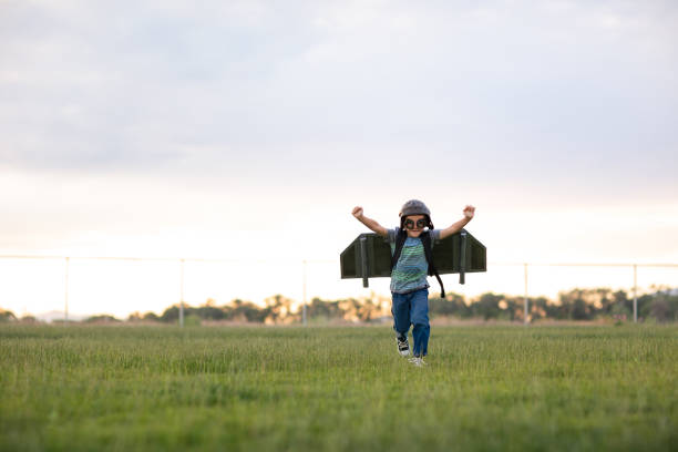 istock Young Boy with Jetpack in Grassy Field 2133953097
